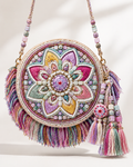 Round fabric bag with a pastel beaded lotus design, multi-colored fringe, and a beaded shoulder strap.